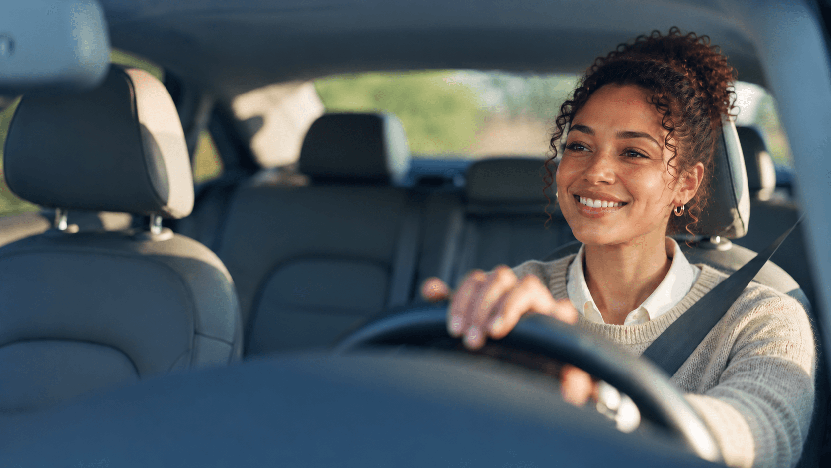 Smiling driver behind the wheel of a car